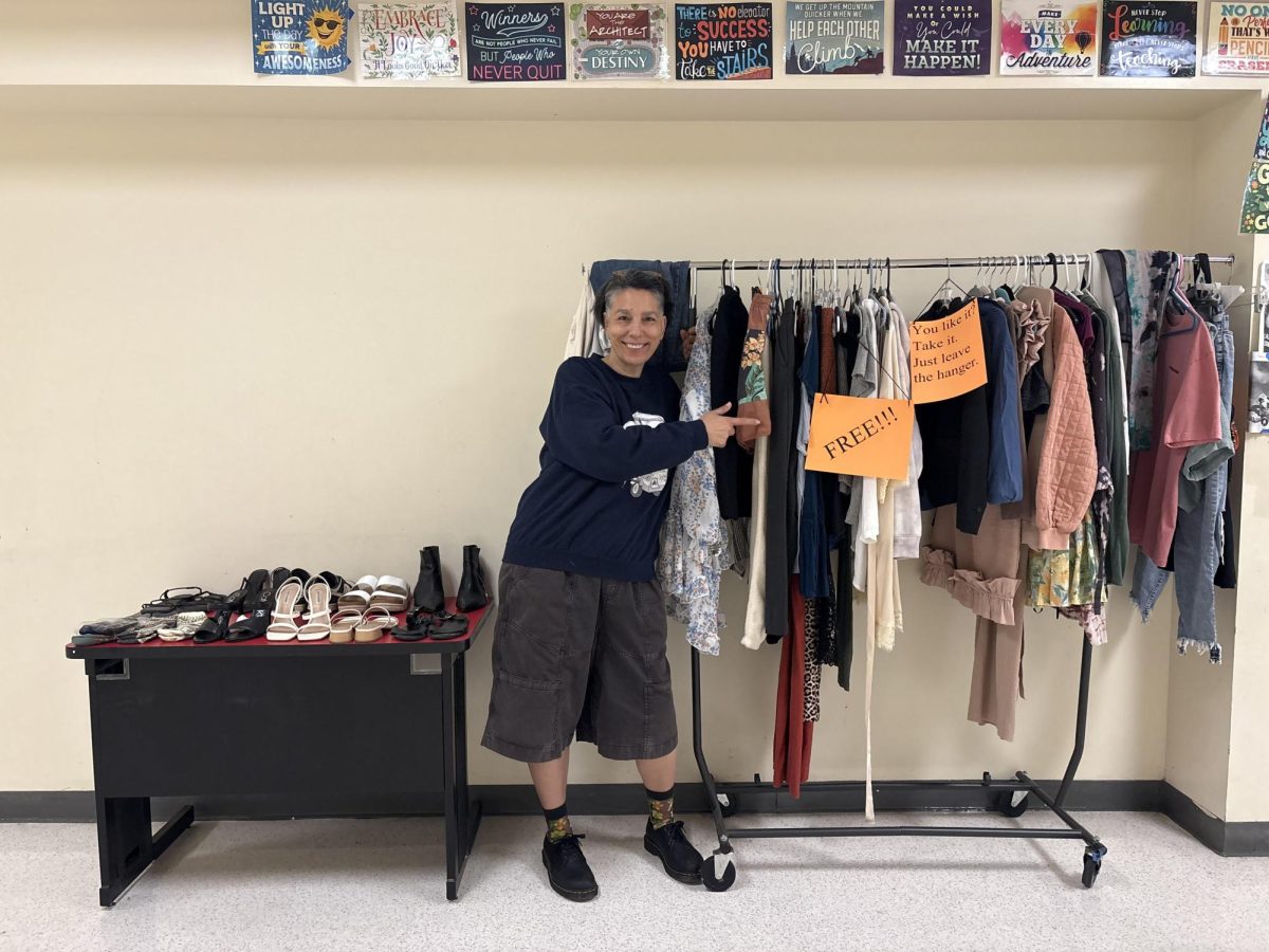 Ms. Greta Sukazian poses with her clothes rack.